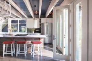 Single family home with a pair of white hinged patio doors leading to the outdoors